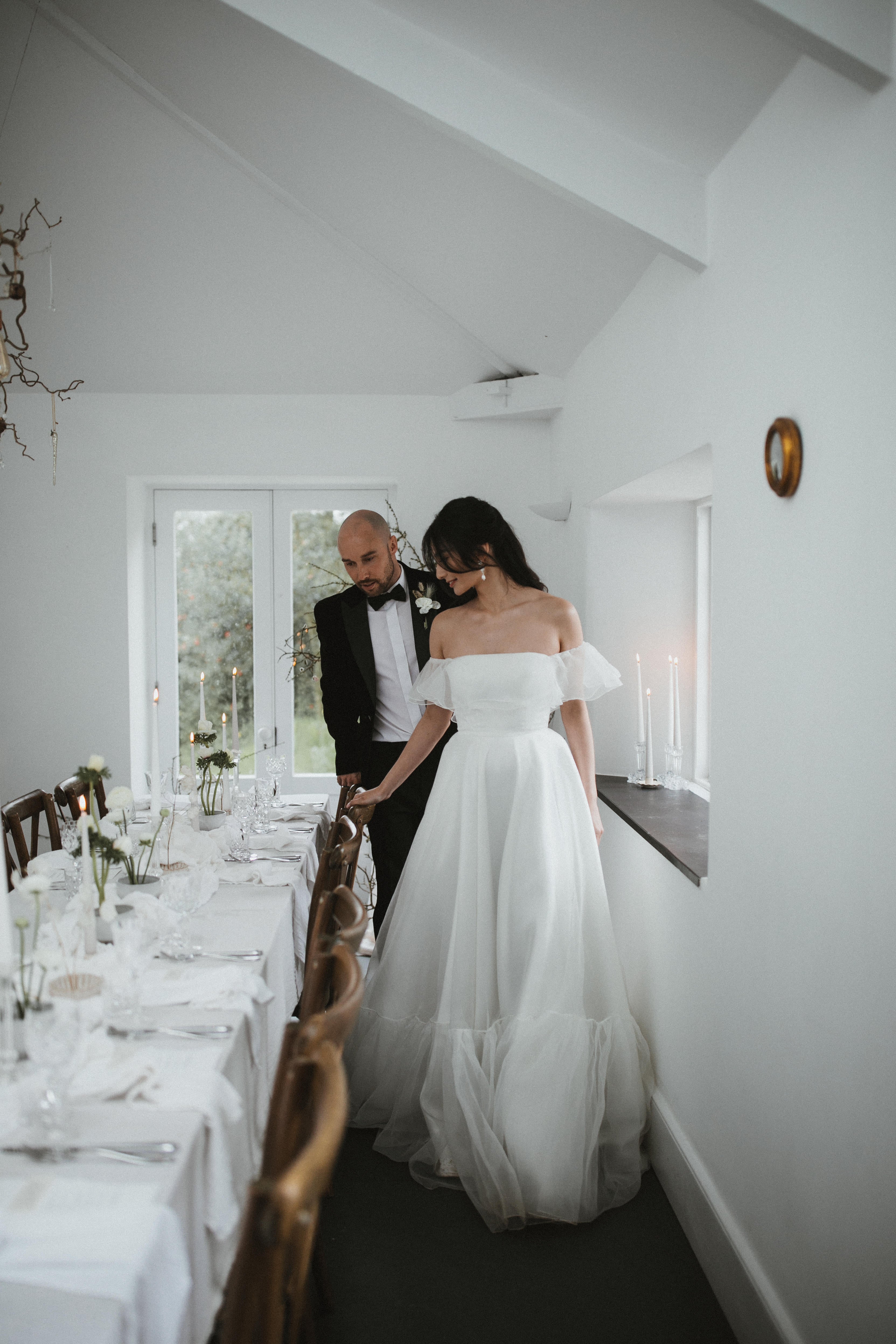 Model wearing our Monroe wedding dress, a structured, corseted organza dress with frill, bardot neckline and pockets.