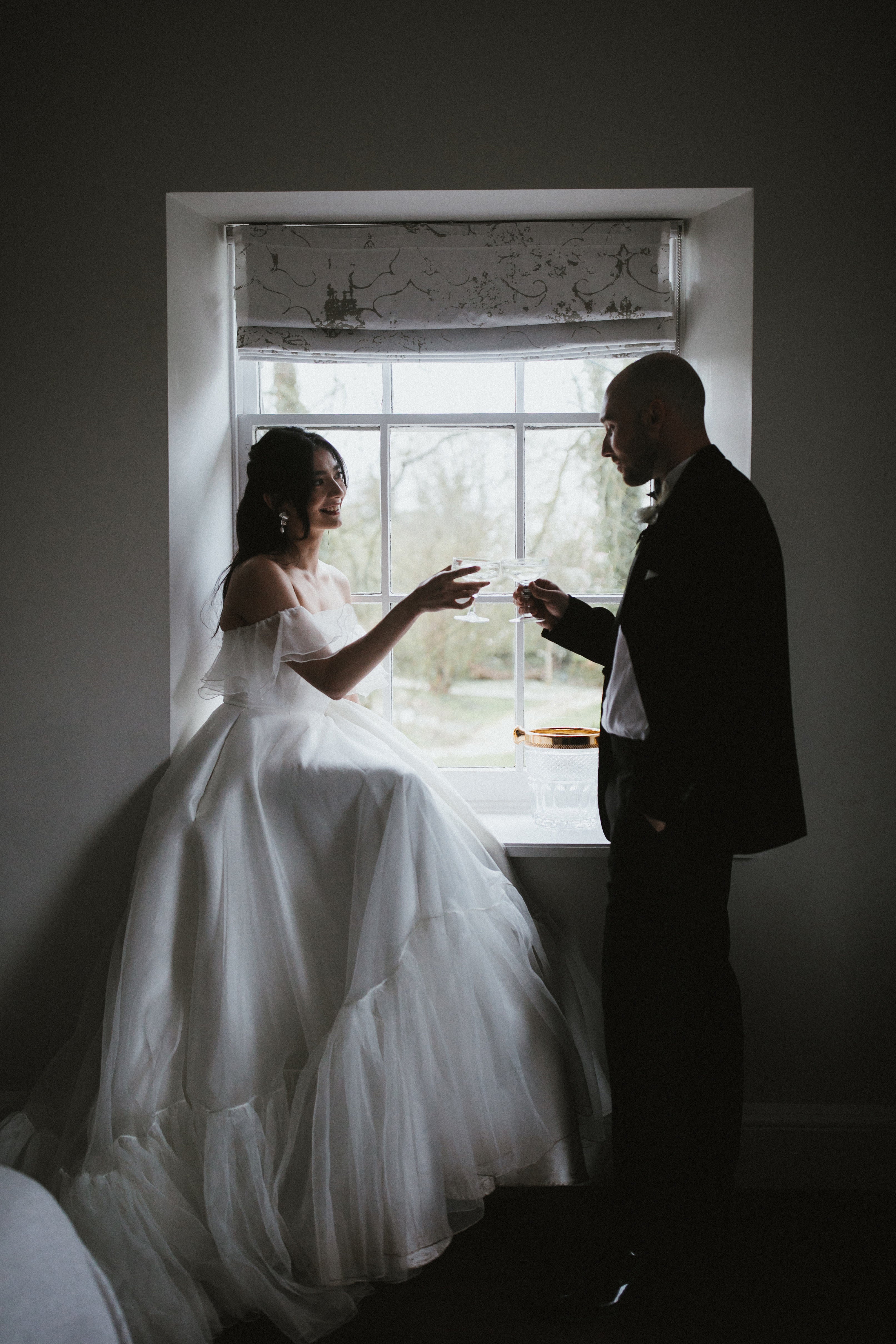 Model wearing our Monroe wedding dress, a structured, corseted organza dress with frill, bardot neckline and pockets.
